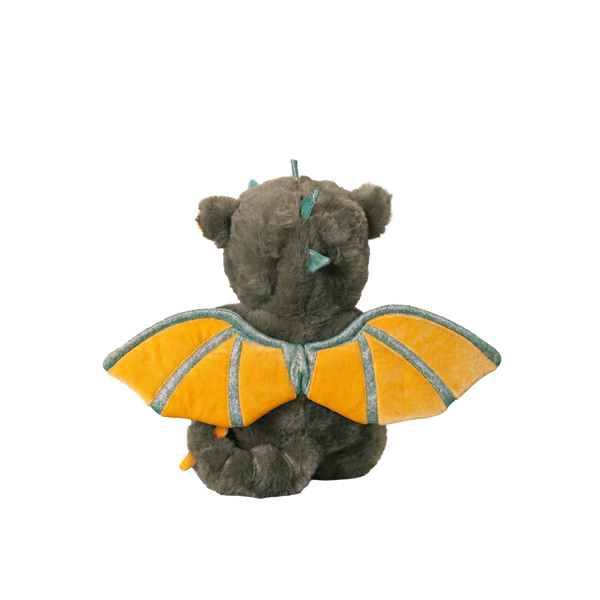 Plush toy resembling a dragon with yellow wings on a white background