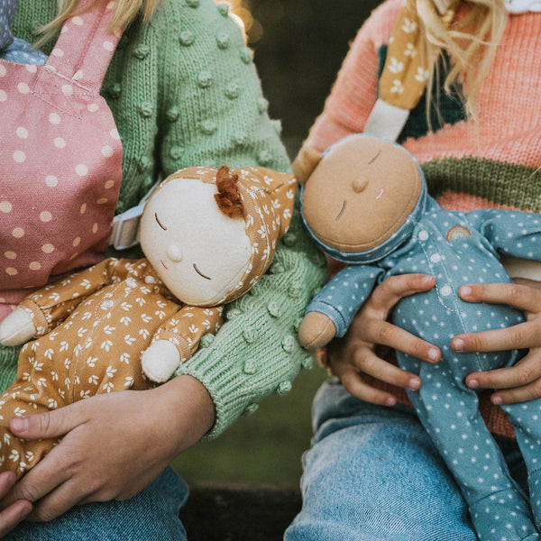 Gender-neutral posable plush doll with blue velvety onsie outfit. Perfectly weighted for cuddles and bedtime. Suitable toy from birth.