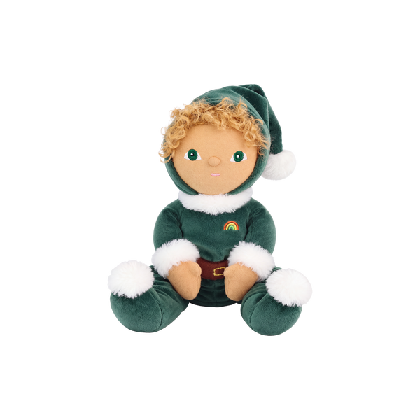 Plush doll with curly golden hair and embroidered green eyes, dressed as a Christmas elf in a dark green velvet suit and pointed hat with white fluffy trim, a brown belt, and a small rainbow patch on the chest.