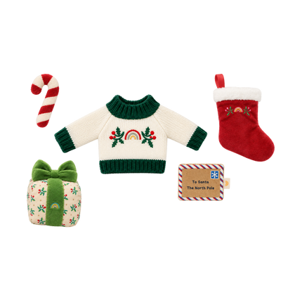 Christmas doll accessory set: a cream knit jumper with green trim and an embroidered rainbow and holly design, a red plush stocking with white fluffy cuff, a red and white striped plush candy cane, a holly-print gift box with a green velvet bow, and a felt “To Santa, The North Pole” letter.