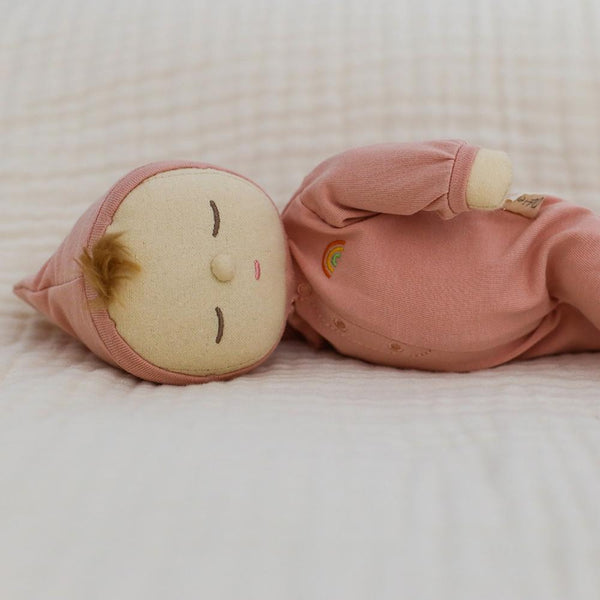 Dozy Dinkums - Moppet soft baby doll in a pink outfit and bonnet lying down with a sleepy embroidered face