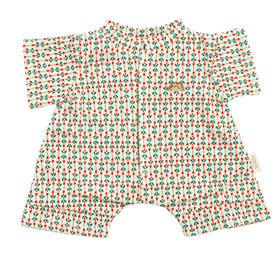 Cream short-sleeved doll romper with a small red and green sprig print, a front placket, short legs, and a small gold embroidered rainbow on the chest.