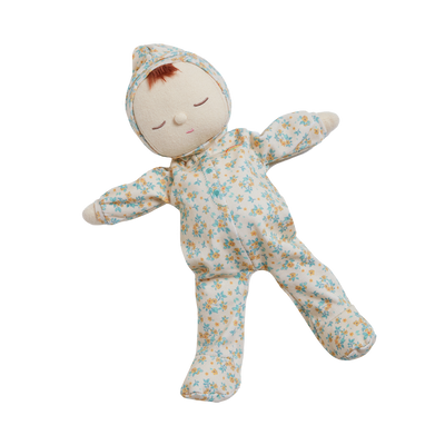 Stuffed baby doll in floral onesie on a white background