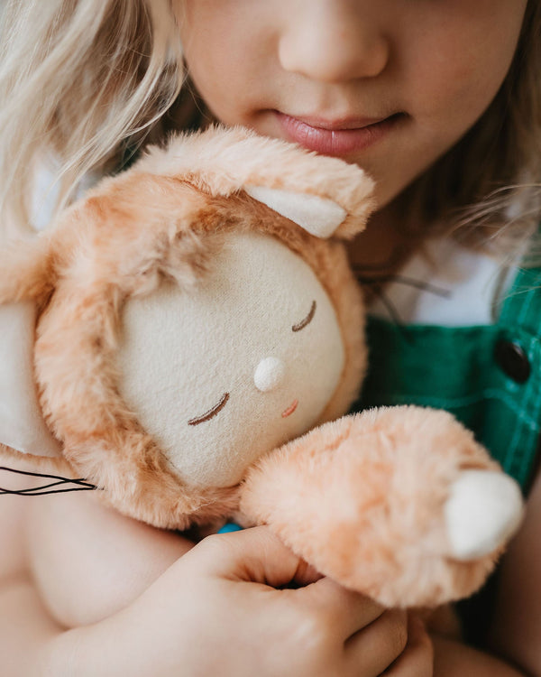 Little girl play with ginger tabby cat, soft plush toy doll for kids