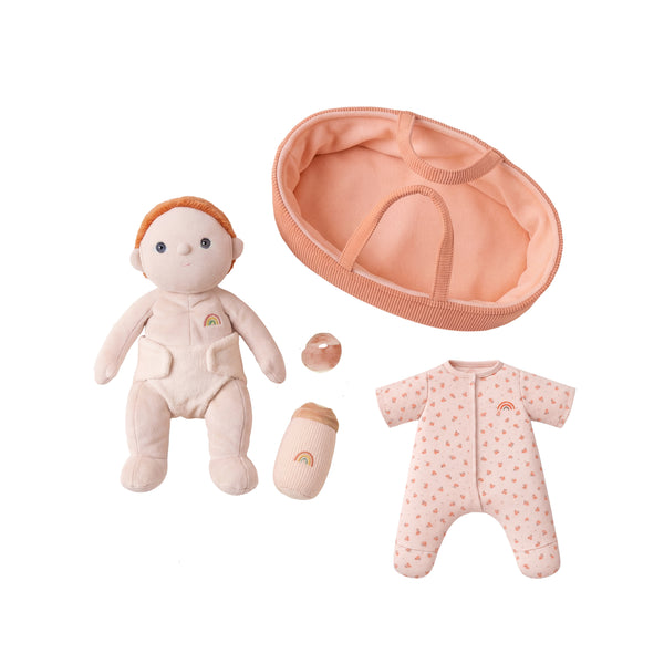 Baby doll with accessories including a hat, bottle, and onesie on a white background