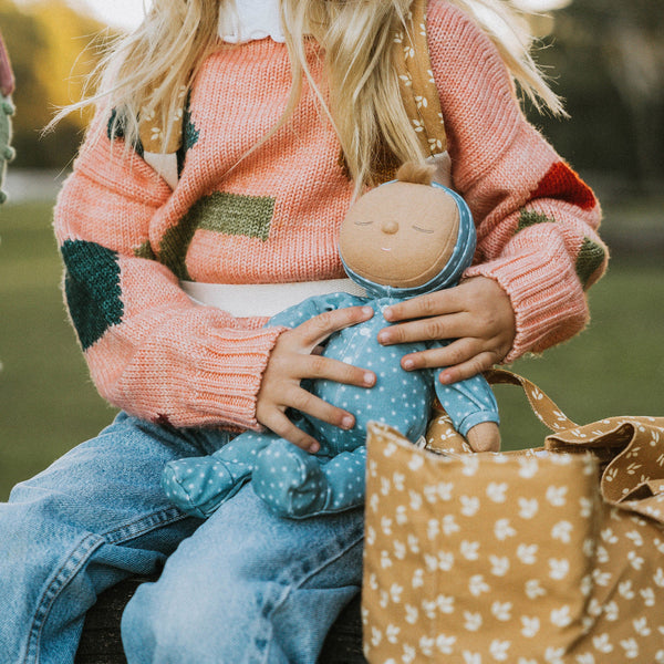 Gender-neutral posable plush doll with blue velvety onsie outfit. Perfectly weighted for cuddles and bedtime. Suitable toy from birth.