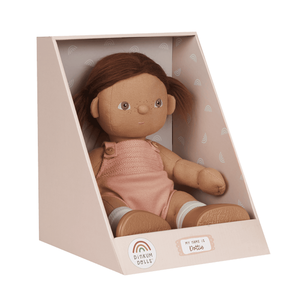 Dinkum Dolls - Dottie soft doll with brown hair wearing a pink knitted romper in a display box for imaginative play