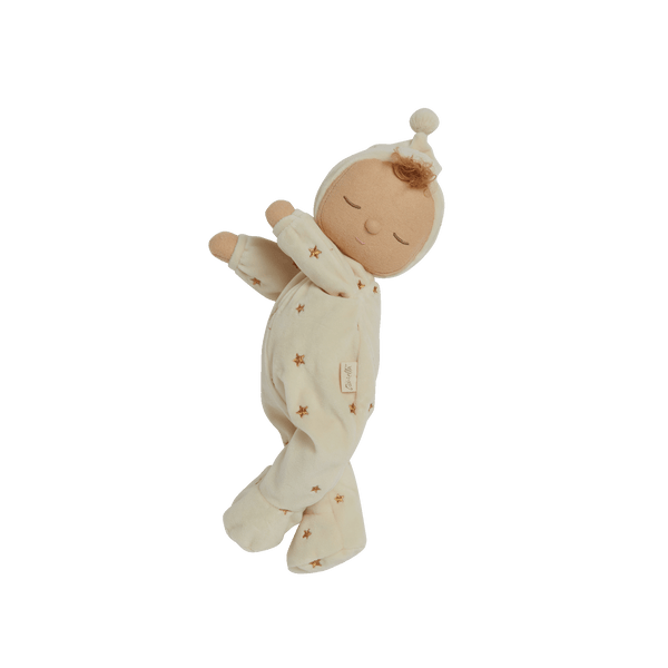 Lullaby Dozy Dinkum - Lyra soft baby doll in a cream star-print sleepsuit and bonnet with a pompom top. Dozy Dinkums plush doll toy shown sleeping.