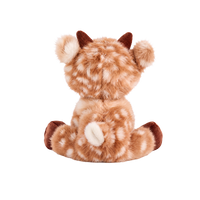 Fluffy plush reindeer with fawn fur and cream spots, a red nose, a smiling cream muzzle, short brown corduroy antlers and hooves, and an embroidered paw-and-rainbow motif on one foot, sitting beside a red and white striped hat.