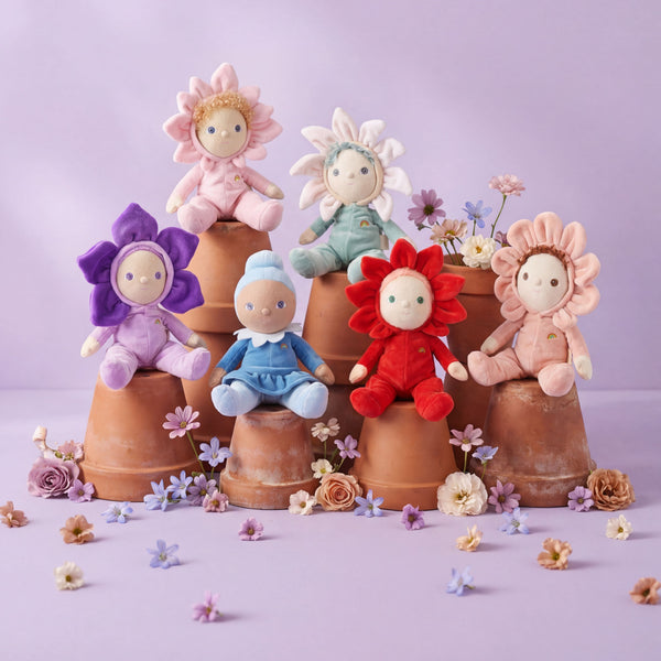 Colorful flower-shaped dolls on terracotta pots with a light purple background
