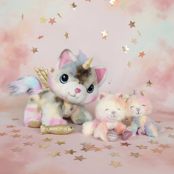 Two plush unicorn toys on a pink background with star decorations
