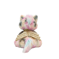 Plush toy resembling a cat with pastel fur and gold accents on a white background