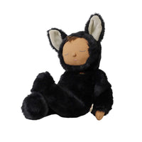 A black plush doll wearing a furry animal hood with long ears, a stitched sleeping face, and a small orange accent near the neck, photographed on a plain white background.