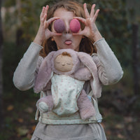 A flower printed dot doll carrier with adjustable straps, perfect for little ones to carry their favorite dolls on adventures. Ideal toddler doll accessory for imaginative parent play.