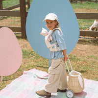 A flower printed dot doll carrier with adjustable straps, perfect for little ones to carry their favorite dolls on adventures. Ideal toddler doll accessory for imaginative parent play.