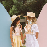 A cozy, bunny-themed pink doll carrier with adjustable straps, perfect for little ones to carry their favorite dolls on adventures. Ideal toddler toy accessory, cuddly easter-themed doll carrier.