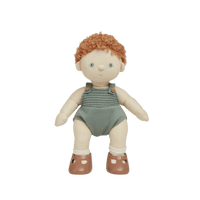 A soft, plush Dinkum Doll with posable arms, legs, and head, wearing a green outfit and brown shoes.