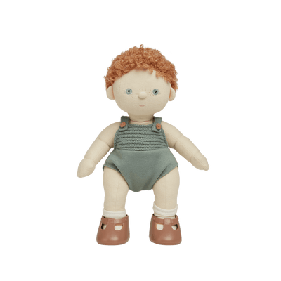 A soft, plush Dinkum Doll with posable arms, legs, and head, wearing a green outfit and brown shoes.