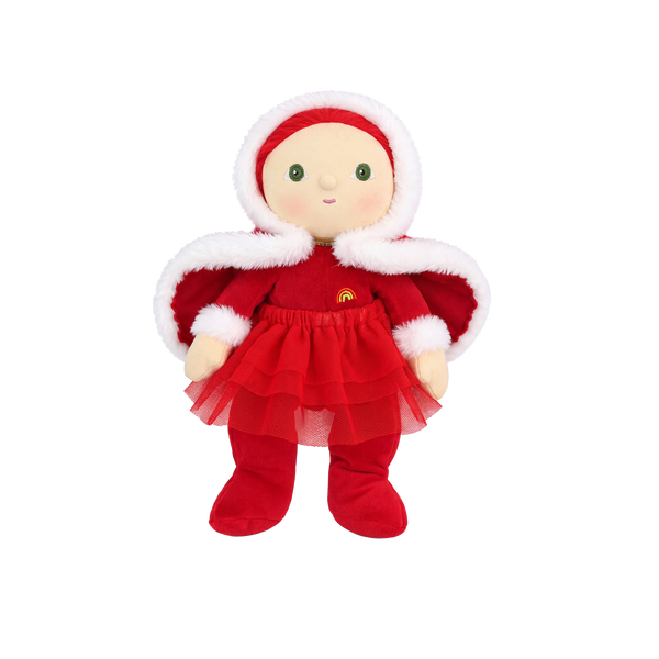 Plush doll with red hair, embroidered green eyes and rosy cheeks, wearing a red velvet hooded cape with white fluffy trim over a red outfit with a tulle skirt, white fluffy cuffs and a small rainbow patch on the chest.