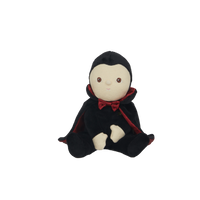 Stuffed toy with a black hood and red trim on a white background