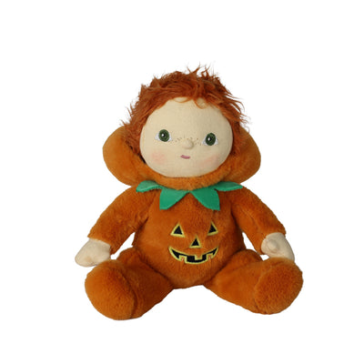A plush doll dressed in an orange pumpkin costume with a green bow tie and embroidered jack-o'-lantern face, seated against a plain white background.