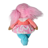 A plush doll viewed from behind, featuring fluffy pink hair in pigtails, a pink and white swirl-patterned dress, a coral-pink top, and light blue pants, set against a plain white background.
