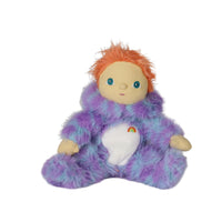A plush doll with orange hair, a beige face, and a fuzzy purple and blue onesie, sitting against a plain white background.