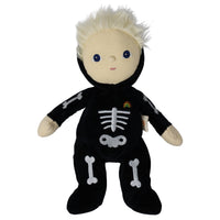 A plush doll with short white hair, blue eyes, and a black onesie decorated with white bone patterns and a small rainbow emblem on the chest, shown against a plain white background.