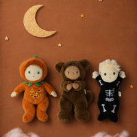 A brown plush teddy bear doll wearing a furry animal hood with small ears