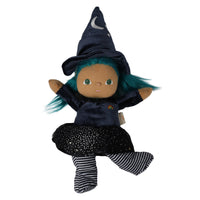 A plush witch doll with brown skin, green eyes, and bright teal hair, wearing a dark navy pointed hat with a white crescent moon, a dark navy dress, a black starry skirt, and black-and-white striped socks, isolated on a white background.