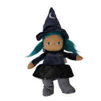 A witch doll plush toy with teal hair, wearing a navy blue velvet hat with a crescent moon and star, a navy long-sleeve top, a black sparkly skirt, and black-and-white striped socks, shown on a plain white background.