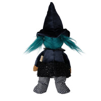 A plush witch doll shown from the back, featuring a black velvet pointed hat, bright teal hair, a black dress with silver glitter trim, and black-and-white striped pants, isolated on a white background.
