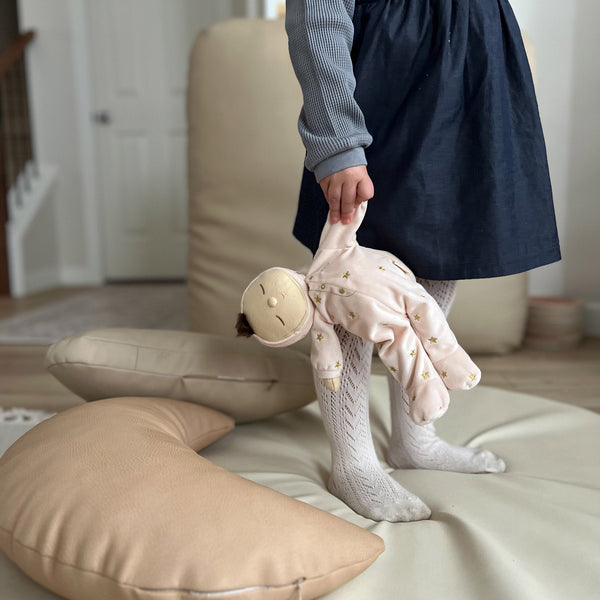 Pink posable plush doll suitable from birth. The Lullaby Luna includes a pompom on their bonnet that plays a sleepy tune when pulled. 