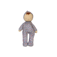 Stuffed doll with floral patterned outfit on a white background