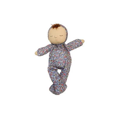 Stuffed doll in a floral outfit on a white background