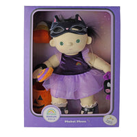 A Mabel Moon Halloween doll by Dream Dinkum Dolls inside its original purple window box packaging. The doll features a black cat mask, a purple dress with a small rainbow, and a purple tutu skirt, holding a candy cane and a jack-o'-lantern bucket.