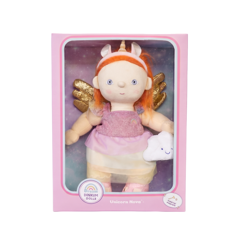 Unicorn Nova Dinkum Dolls soft doll with bright ginger hair pink dress golden wings and a white unicorn companion displayed in a pink gift box