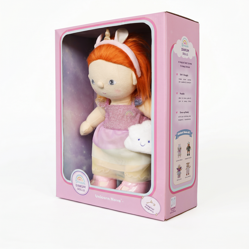 Unicorn Nova by Dinkum Dolls soft doll with bright ginger hair wearing a pink outfit and unicorn headband in a playful pink presentation box