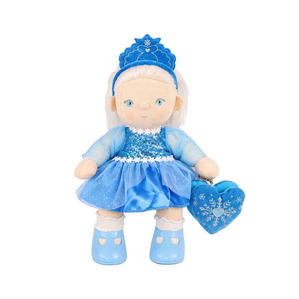 Plush doll with white hair, blue eyes and rosy cheeks, wearing a blue velvet tiara, a sequinned blue dress with sheer sparkly sleeves and a tulle skirt, white frilled socks, light blue shoes, and a blue heart-shaped bag with an embroidered snowflake.