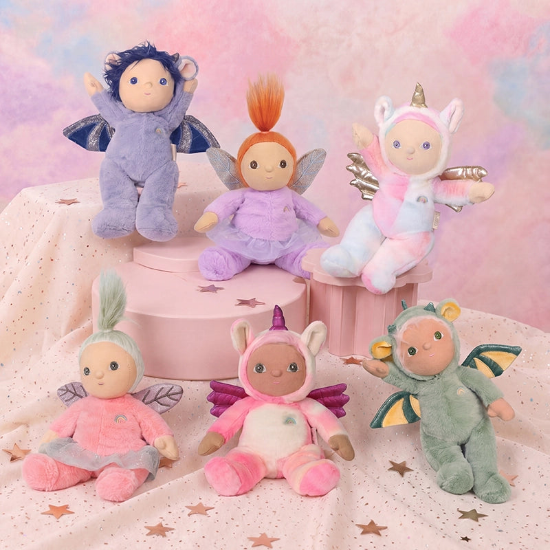 Dinky Dinkum - Yara Unicorn soft doll in a pink and white unicorn outfit surrounded by colorful Dinky Dinkums soft dolls
