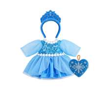 Blue doll dress-up set: a sequinned blue dress with sheer sparkly sleeves, white daisy trim and a layered tulle and satin skirt, a blue velvet tiara headband with embroidered snowflake detail, and a heart-shaped velvet bag embroidered with a silver snowflake on a gold chain.