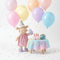 Doll with a birthday hat and cake, surrounded by colorful balloons and confetti on a light background