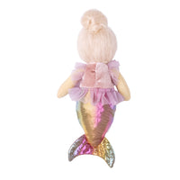 A plush mermaid doll viewed from the back, featuring blonde hair in a bun, a pink ruffled top, and an iridescent gold and pink tail, set against a plain white background.