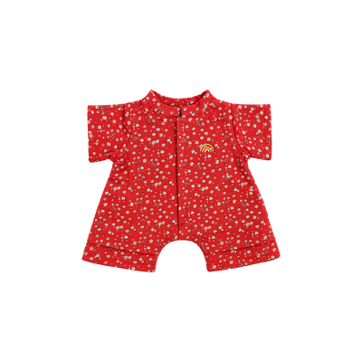 Red short-sleeved doll romper with a ditsy pink and white floral print, a front placket, short legs, and a small yellow embroidered rainbow on the chest.