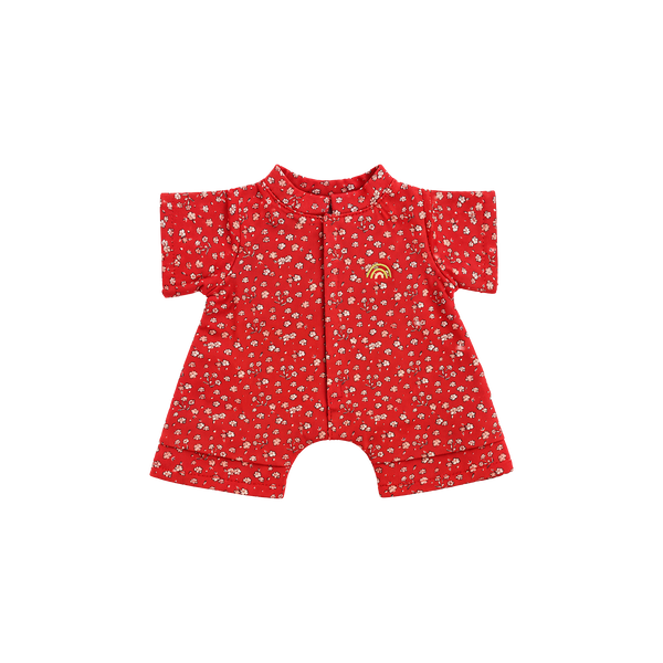 Red short-sleeved doll romper with a ditsy pink and white floral print, a front placket, short legs, and a small yellow embroidered rainbow on the chest.