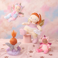 Set of fairy-themed dolls and plush toys on a soft, cloud-like background.