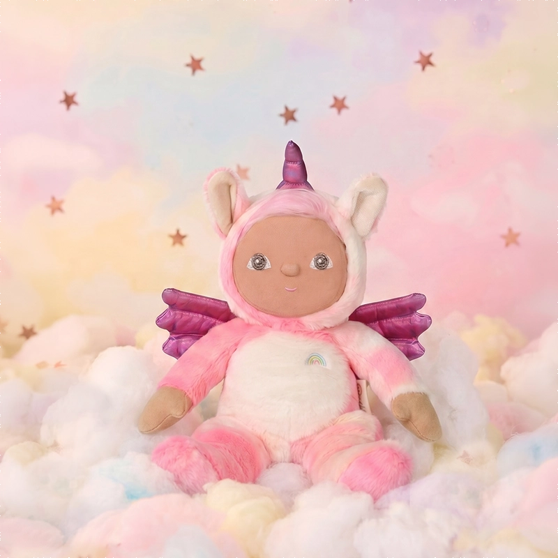 Dinky Dinkum - Yuna Unicorn soft doll by Dinky Dinkums in a pink unicorn costume with wings and rainbow detail sitting among pastel clouds