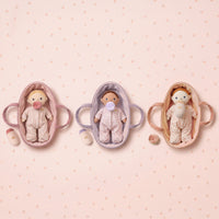 Three baby模拟器 in different colors on a pink polka dot background
