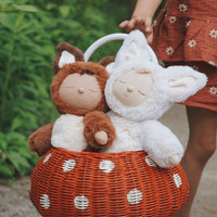 Cozy Dinkums - Fox - Fenix white fox soft doll cuddled beside a brown fox doll in a woven basket outdoors by Dozy Dinkums