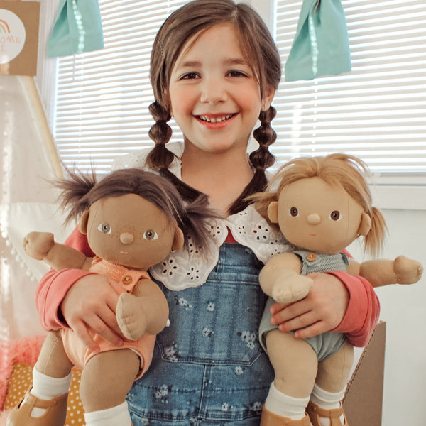 Dinkum Dolls - Dottie soft doll held by a smiling child alongside another soft doll during imaginative play